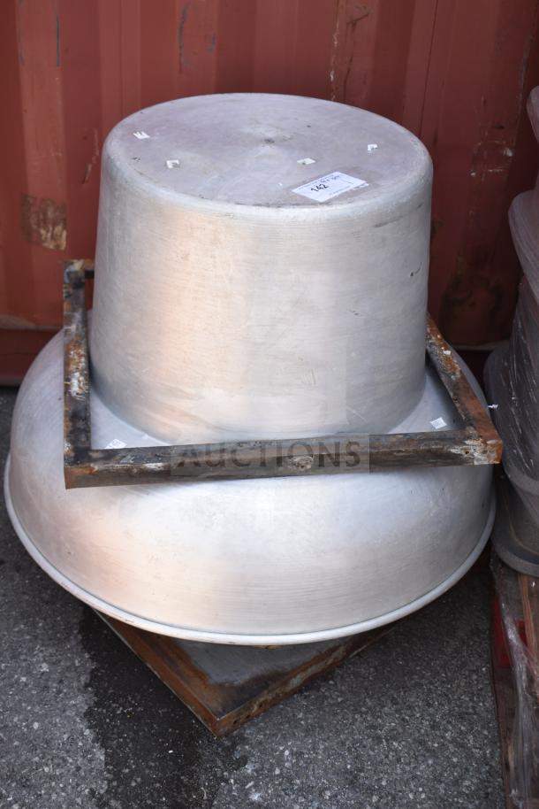 Commercial rooftop mushroom exhaust fan, metal construction, used condition, visible rust on base, auction tag labeled "142".