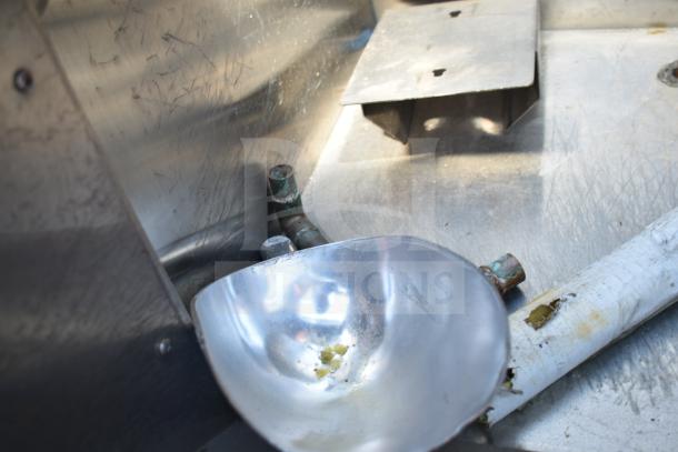 MGR Commercial Ice Bin, scratched stainless steel interior, visible metal pipes, moderate wear, designed for heavy-duty use.