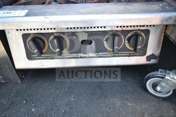 Star Max Commercial Gas 4 Burner Range, used condition, visible wear, labeled Ultra Max, features four control knobs.