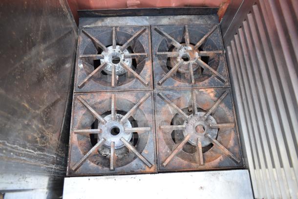 Star Max Commercial 4 Burner Gas Range, countertop model, visibly used condition with signs of wear on burners.