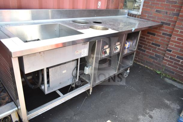 Commercial work station with Alto Shaam 200-CW cold pan drop-in, 2 round steam wells, on wheels, stainless steel finish.