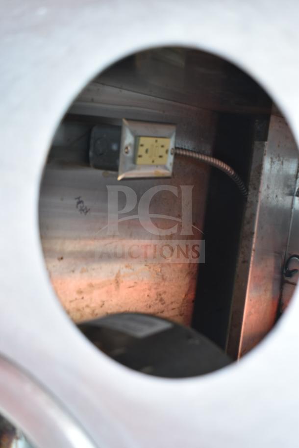 Commercial work station with Alto Shaam 200-CW cold pan drop-in and two round steam wells. Metal interior, electrical outlet visible.