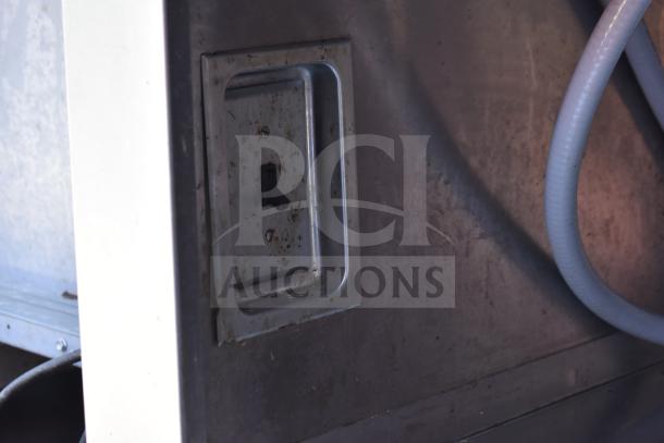 Commercial work station with Alto Shaam 200-CW cold pan drop-in, two round steam wells. Visible wear and utility port.