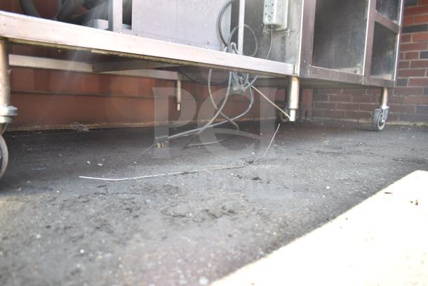 Commercial work station with Alto Shaam 200-CW cold pan drop-in, two round steam wells, visible cords, and caster wheels.