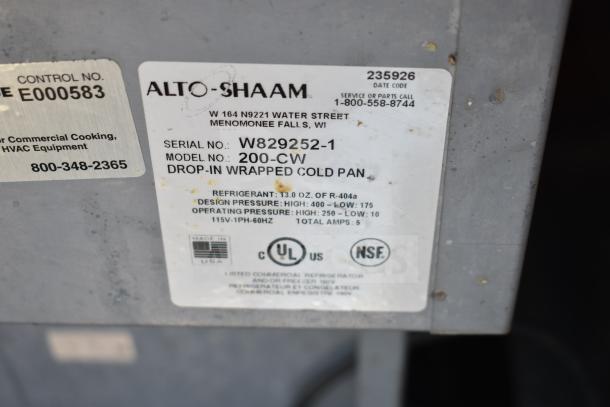 Alto Shaam 200-CW Cold Pan Drop-In label with model, serial number, and technical details on a commercial work station.