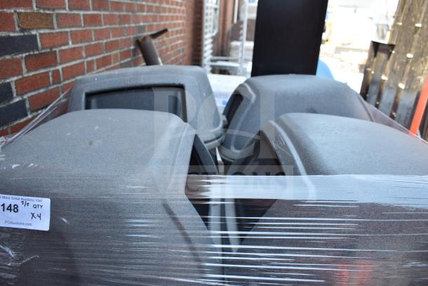 Four gray poly trash cans in good condition, wrapped in clear plastic. Auction label indicates quantity four.