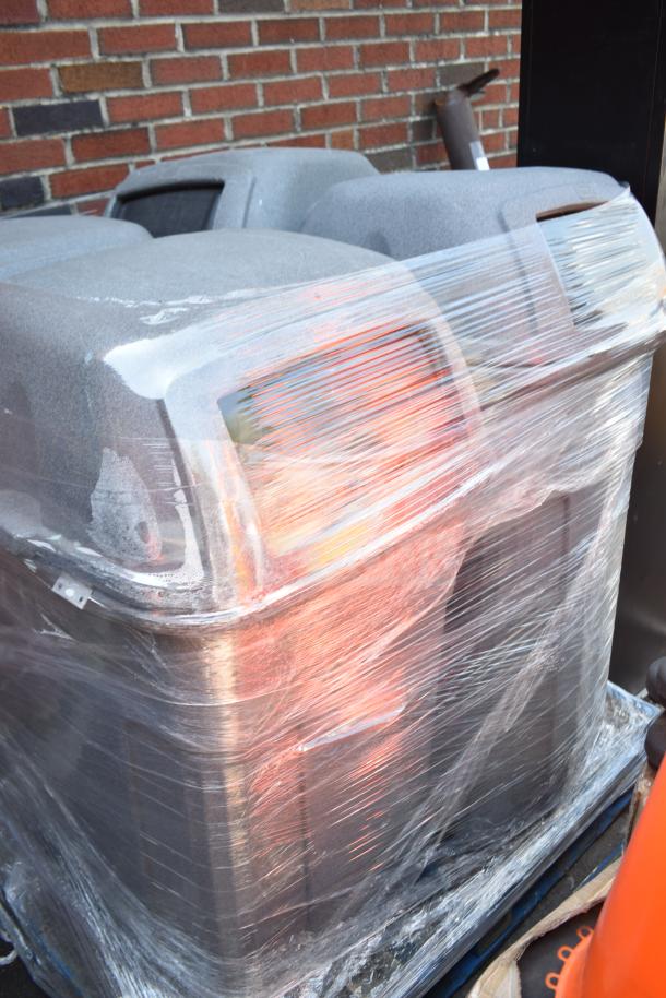 Four gray poly trash cans wrapped in plastic, stacked on a pallet, ideal for bulk waste management. Condition appears good.