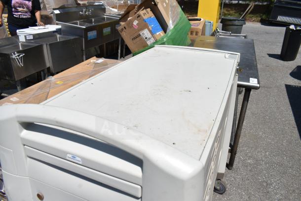 Capsa Solutions XL2097599 cart on commercial casters, used condition, white, sturdy build, suitable for storage or transport.