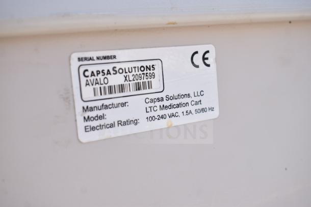 Capsa Solutions XL2097599 cart label showing serial number, manufacturer, and electrical rating details.
