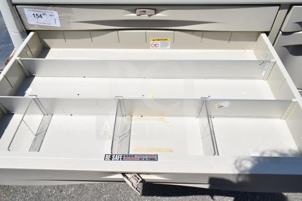 Capsa Solutions XL2097599 cart drawer open, showing dividers and caution labels. Commercial casters for mobility.