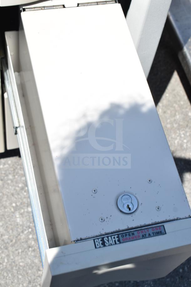 Capsa Solutions XL2097599 cart on commercial casters, featuring a secure lock and safety warning label to open one drawer at a time.