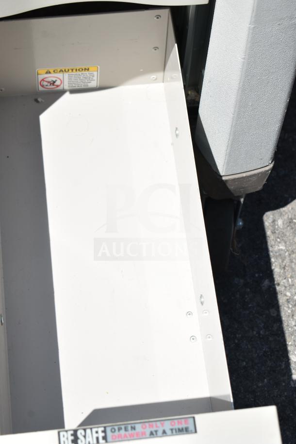 Capsa Solutions XL2097599 cart with commercial casters, open drawer showing caution labels.