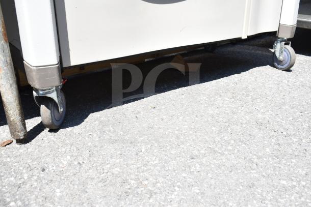 Capsa Solutions XL2097599 cart with commercial casters, shown outdoors, highlighting durable wheel design.