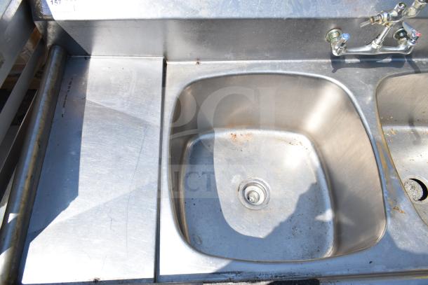 Commercial 3 bay sink, stainless steel, no legs, faucet included, some surface wear visible.