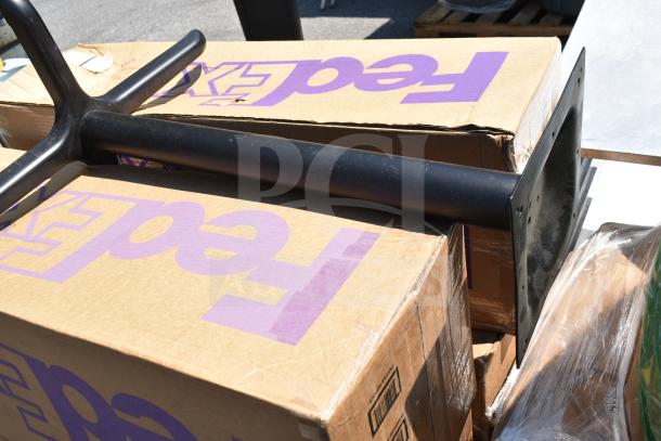 5 brand new outdoor table bases, scratch and dent, on FedEx labeled boxes, black metal finish.