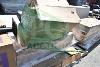 Stack of six brand new items, including a hand sink and café barstool, partially wrapped, showing visible packaging dents.