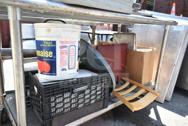 Commercial metal table with under shelf; includes bus bin lids, chair, bowl, and labeled mayo container; used condition.