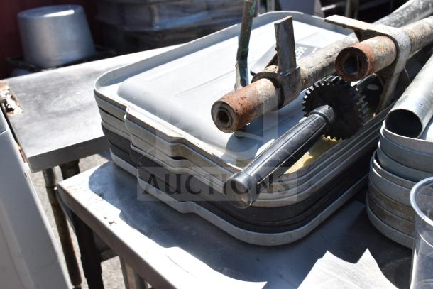Commercial table with stacked bus bin lids, metal chair, and bowl. Includes under-shelf storage, used condition.