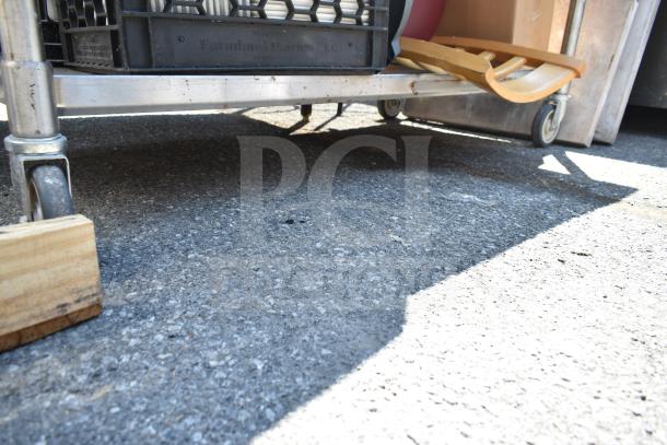 Commercial table with under shelf, includes bus bin lids, chair, and bowl. Visible markings: Farmland Dairies LLC.