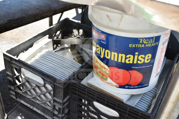 Commercial table with under shelf holding bus bin lids, a chair, and a bowl. Includes mayo container. Used condition.