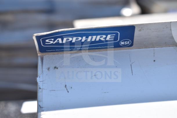 Sapphire wall mount shelf with visible logo and NSF certification, showing surface wear. Brand: Sapphire.