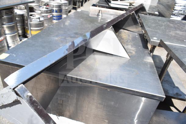 Sapphire wall mount shelf; stainless steel, triangular design, shows signs of wear, sturdy construction, ideal for storage.