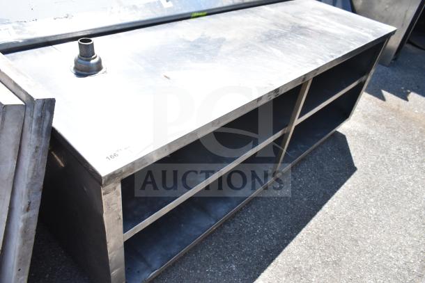 Commercial table with under shelves, stainless steel, used condition, features multiple storage shelves, durable build.