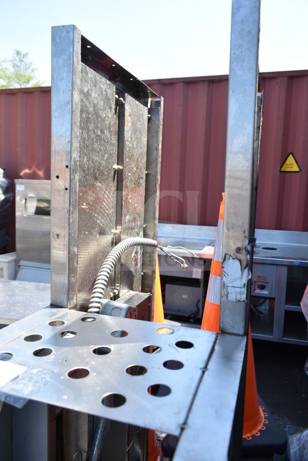 Over shelf with Hatco Glo Ray food warming strip, stainless steel, visible wiring, used condition, industrial setting.