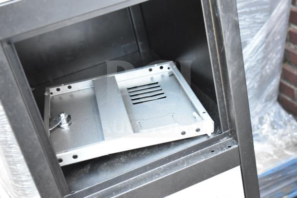 Fedmax gray and black 6 cubby locker, open cubby view, metal construction, good condition, secure lock mechanism.