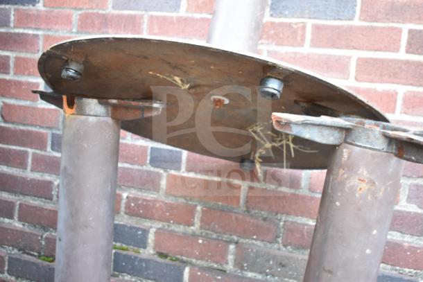 Rusted metal table base with three round legs and a circular mount, suitable for DIY projects.