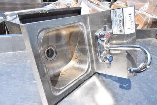 Krowne HS-9L 14 1/4" x 12" wall-mounted stainless steel hand sink with faucet, showing wear and metal finish.