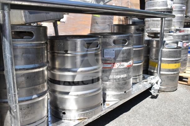 Commercial table with under shelf holding multiple kegs, various labels visible. Durable construction, no sink included.