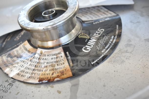 Commercial table with under shelf, includes kegs. Table surface shows Guinness keg branding and government warning. Sink not included.