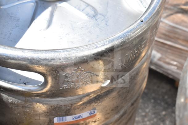 Silver half-size barrel keg with embossed logo and "ANHEUSER" text, showing signs of use. Marked with auction label.