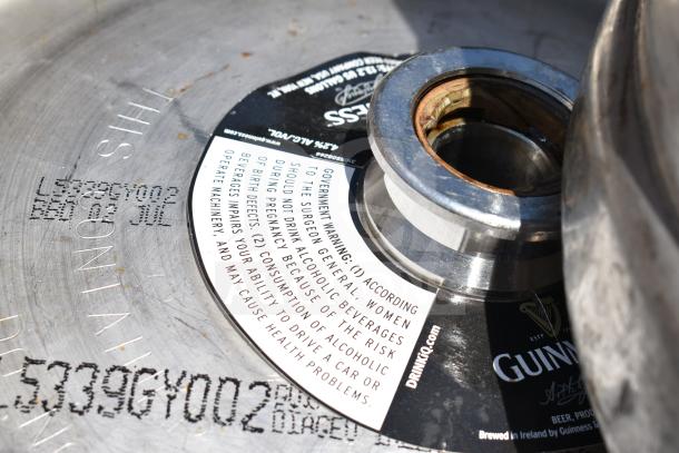10 half-size Guinness barrel kegs with government warning labels. Branded and marked with product details. Used condition.