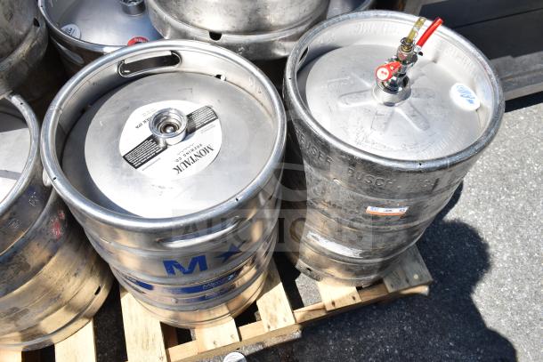 10 metal half-size barrel kegs on a pallet, brands Montauk Brewing Co. and Anheuser-Busch visible. Used condition.