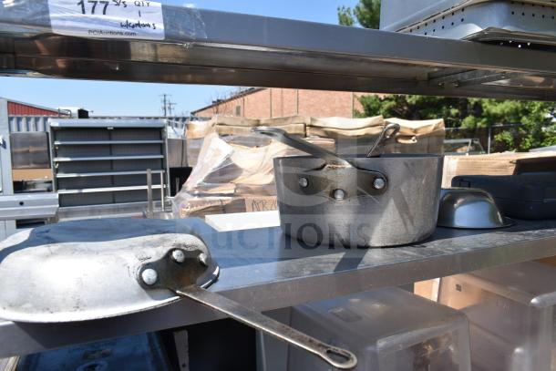 Commercial table with two-tier over shelf and under shelf, including pots and pans. Visible label: "177 S/S QTY."