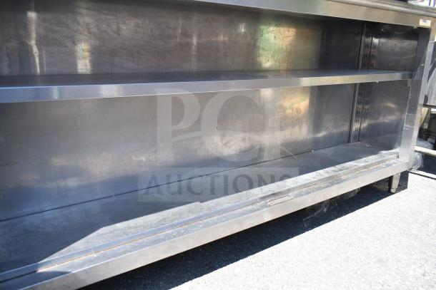 Commercial stainless steel table with 2-tier over shelf, under shelf, and contents. Clean, spacious design for versatile use.