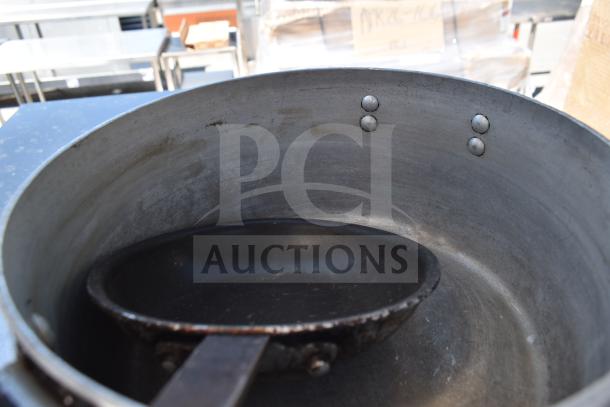 Commercial table with two-tier over shelf and under shelf, shows large pot and pan in used condition.