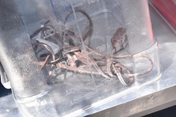 Commercial table with two-tier over shelf, under shelf, and contents including wire storage. Silver finish, sturdy condition.