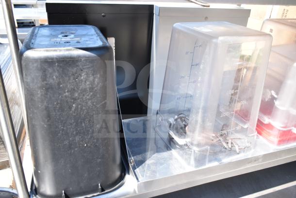 Commercial table with 2-tier over shelf, under shelf, and contents including storage bins and lids. Good condition.