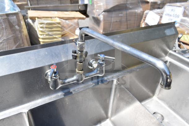 Commercial 3 bay sink with dual hot and cold water faucets, stainless steel construction, excellent condition.