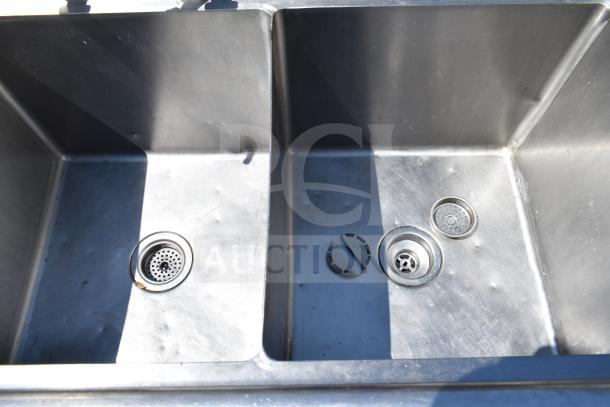 Commercial 3 bay stainless steel sink in good condition, showing three basins with drains. Ideal for restaurant use.