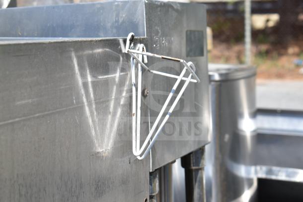 Commercial ice bin with cold plate, stainless steel, used condition, external white frame attachment, visible wear marks.