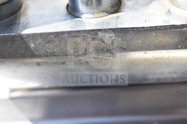 Commercial single bay sink with visible Krowne branding, stainless steel construction, and signs of wear.