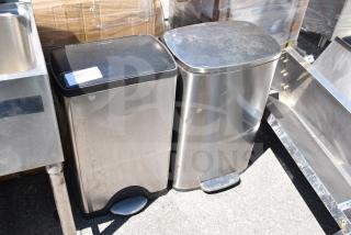 Two metal foot pedal trash cans, stainless steel, square design, moderate wear, one with a visible label.