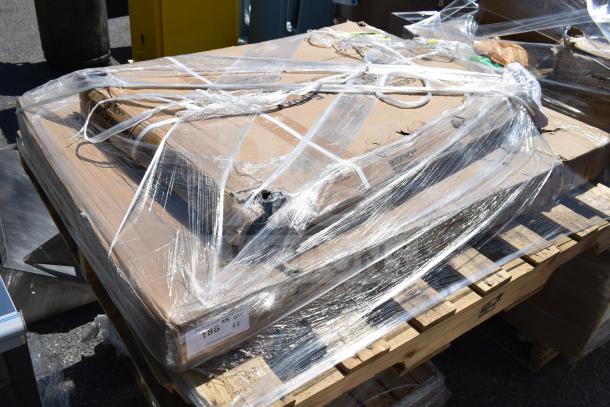 Three brand new scratch and dent items including an ice bin and wire shelves, wrapped in plastic on a pallet. Marked "Regency."