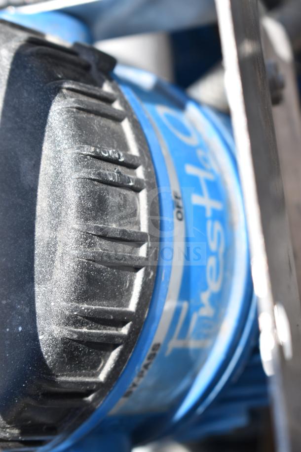 Close-up of a black and blue knob with "Firestone" and "BYPASS" markings, part of an auction lot with various items.
