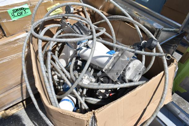 Lot of assorted cables and components in a cardboard box, marked "Skid 4 of 5." Items appear used, mixed condition.