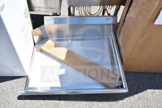 "Regency 600CDT36R 16 gauge 3' clean dish table with right drainboard, scratch and dent condition, visible label."